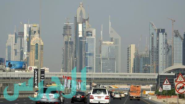 Cars drive on a highway in the Gulf emir