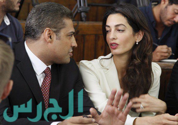 Fahmy talks to his lawyer Amal Clooney before hearing the verdict at a court in Cairo
