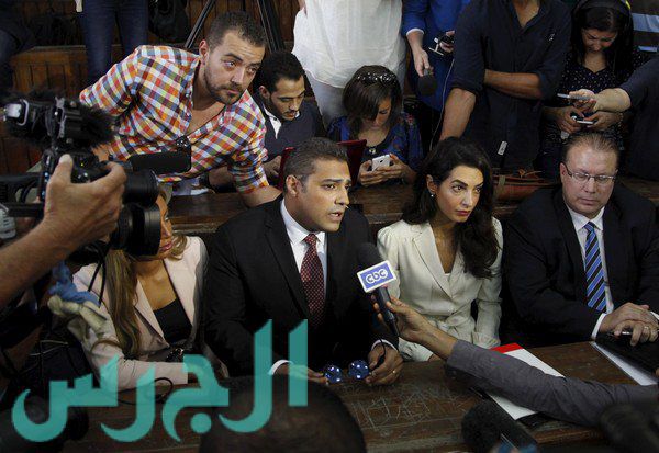 Fahmy and Mohamed talk to the media at a court in Cairo