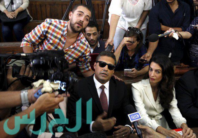 Fahmy and Baher Mohamed talk to the media before hearing the verdict at a court in Cairo