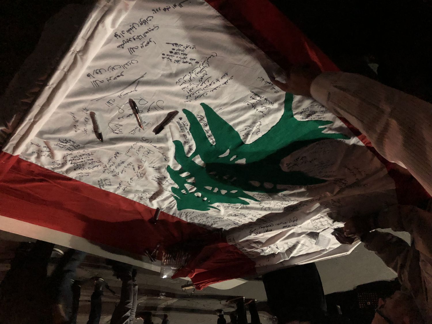 Large Lebanese Flag Signed By Attendees In LA’s Vigil For Lebanon’s Revolution Martyrs